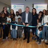 Dr. Niall Muldoon, Ireland’s Ombudsman for Children, cutting the ribbon at the official launch of the new POD Play Hub at the IPAS centre in Westside Apartments, Letterkenny.