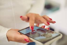 Hands of a young female choosing a boyfriend or possible husband in online dating application
