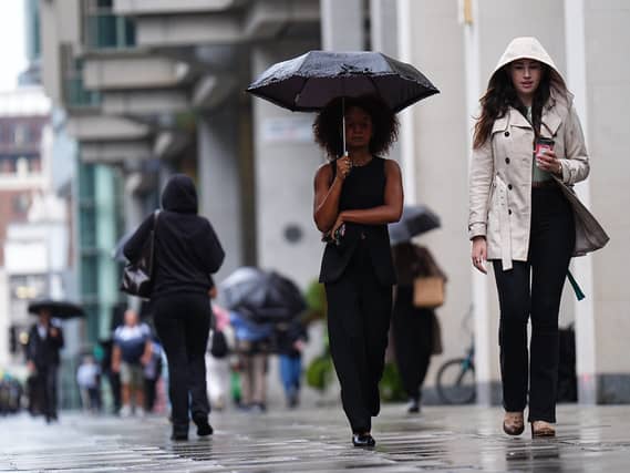 People walking in the rain in Victoria Street, central London