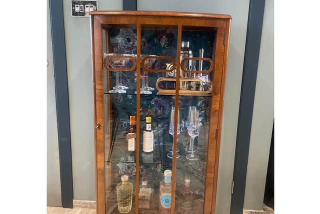 Art-deco cabinet with vintage gold leaf on glass, Lia Gold wallpapered the back and styled as a home bar cabinet (Lia Gold Interiors/PA)