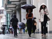 People walking in the rain in Victoria Street, central London