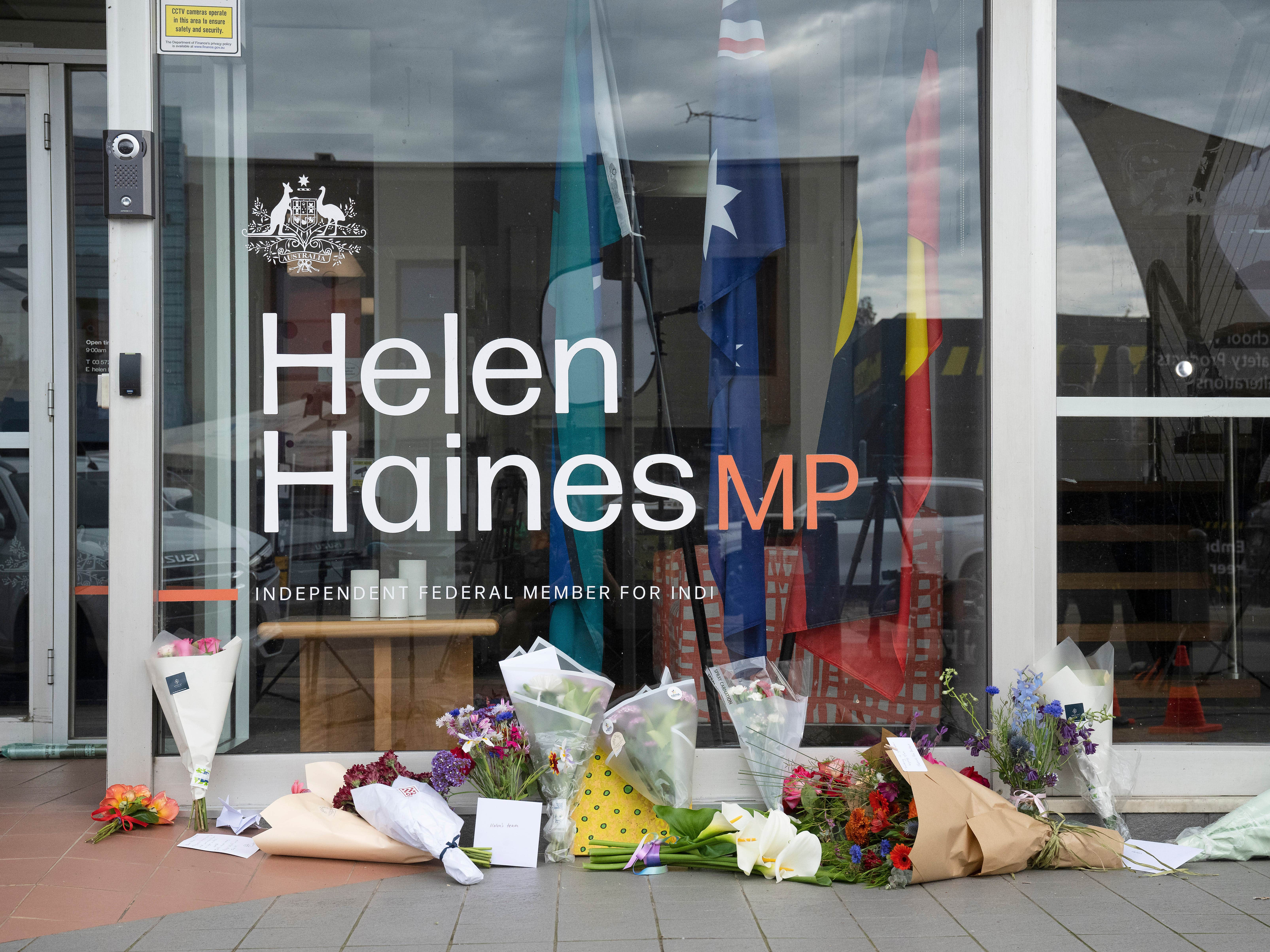 Tributes and flowers are placed outside the electoral office for independent member of parliament Helen Haines in Wangaratta