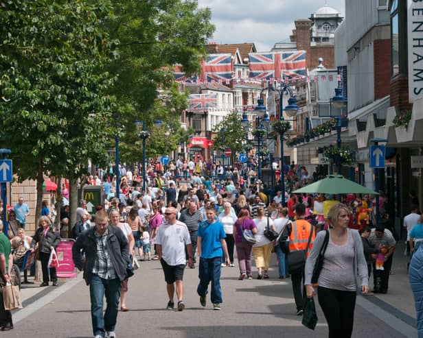 Crowded Town Centre Busy With High Street Shoppers