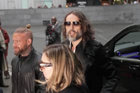 Russell Brand (centre) arrives with his wife Laura Gallacher at Southwark Crown Court