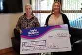 Anne Mullan, Quigley’s Point, presents a cheque for €2,240 to Ailbhe McDaid of Foyle Hospice