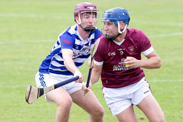 Leixlip midfielder Eoghan Harrington shakes off the challenge from Sean MacDonncha of Naas in 2026 IHC action