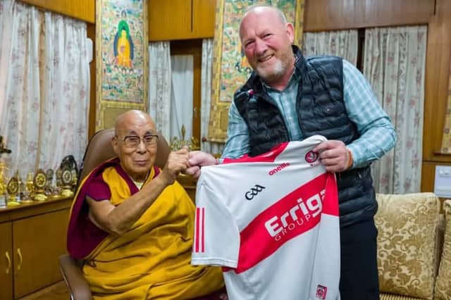 Greg McLaughlin presents His Holiness the Dalai Lama a Derry GAA jersey.