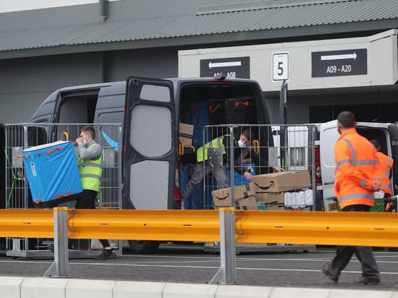 View of workers loading vans at an Amazon warehouse