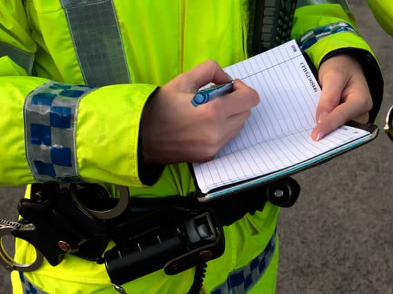 Police officer writing in notebook