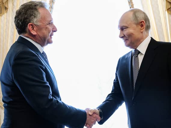 Russian President Vladimir Putin, right, greets US envoy Steve Witkoff