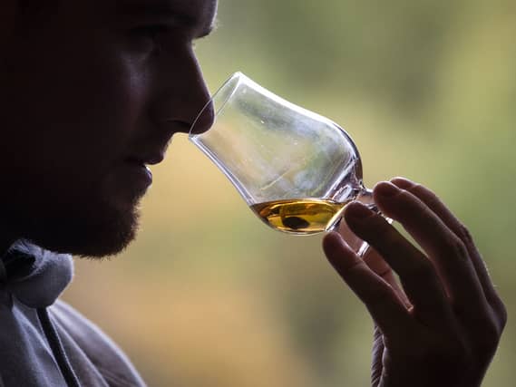Someone sniffs at a nice Scotch whisky