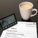 A smart meter next to an energy bill