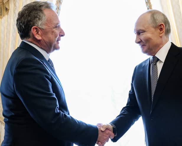 Russian President Vladimir Putin, right, greets US envoy Steve Witkoff