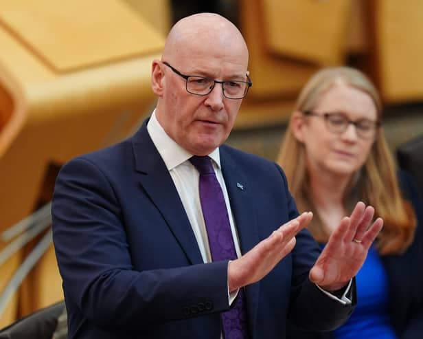 John Swinney standing while speaking in Holyrood