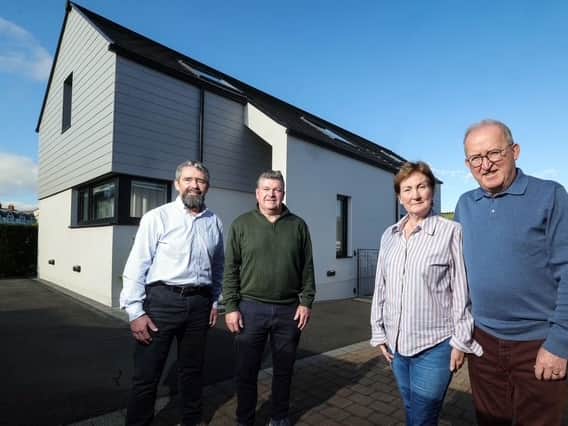 Pictured (from left) are Mark & Niall Gribbin, Directors of Setanta Construction; with homeowners Anne-Marie & Eddie McGoldrick outside their full-electric, smart tech home on the outskirts of Cushendall, Co. Antrim.  The energy-efficient property costs just £44 per week to run, including electric vehicle charging, showcasing the potential of modern, sustainable home design and construction.