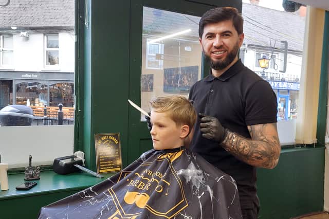 Dio in Bozz Barbers on Portlaoise Main Street, with young customer Billy Kelly.