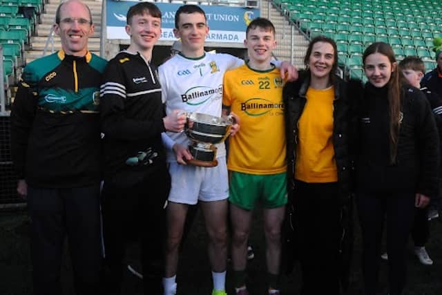 Ballinamore Sean O’Heslin’s Goalkeeper Mark Aherne holding the Fenagh cup with his family after the club's Leitrim Senior Championship Final win on Sunday.