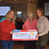 Pictured is Joanne McCallister, Chief Executive Officer at Children’s Heartbeat Trust, receiving a cheque from Julie Wallace, Lifestyle Care Home Manager at Milesian Manor, alongside resident Pat Kirkwood.