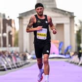 Stephen McAuley crossing the finish line at the 2026 Dublin Marathon