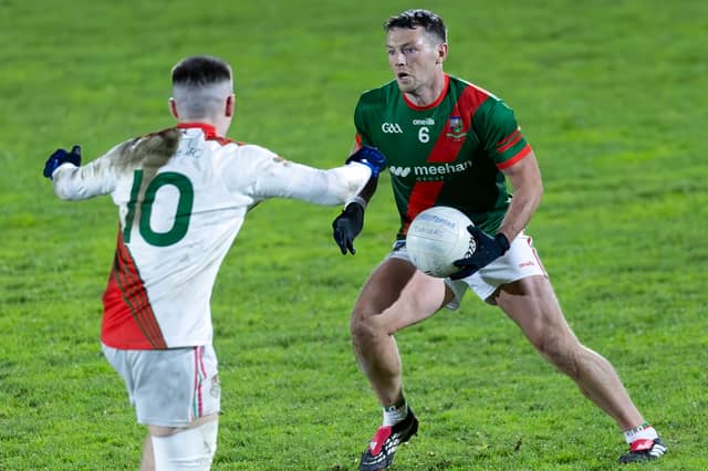 Milltown goal-scorer Colin O'Shea weighs up his options as Eoghan Lawless of Suncroft attempts to close him down