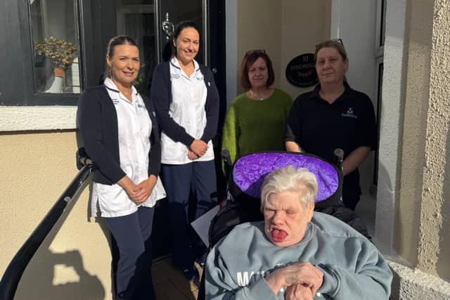 L-R: Samantha Boyle, Learning Disability Occupational Therapist; Caoimhe Kirkpatrick, Learning Disability Occupational Therapist; Sonia Bradley, Duncreggan Residential Home Manager; Sarah Toner, Duncreggan, standing with Elizabeth in her new bespoke moulded wheelchair.