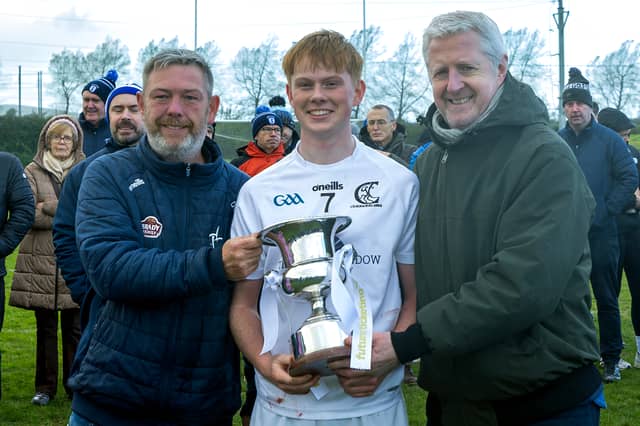 Clane Captain Eoghan Little accepts the Minor Hurling A Championship Cup from David Cahill Kildare GAA and Ronan Burns from Future Ticketing