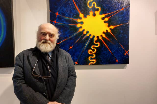 Birr artist Chris O’Donoghue standing in front of one of his paintings. The exhibition runs until the end of November and the paintings are for sale.