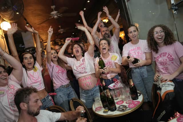 People spray sparkling wine as they celebrate early exit poll results (Oded Balilty/AP)