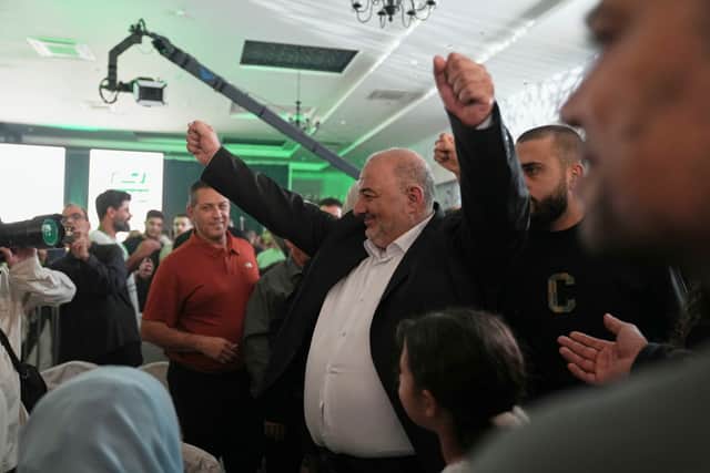 Mansour Abbas, leader of the Ra’am party, raises his fists as he greets supporters (Mahmoud Illean/AP)