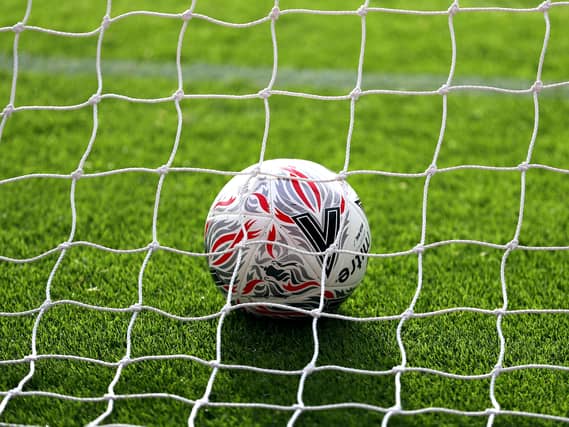 A football lying in a goal