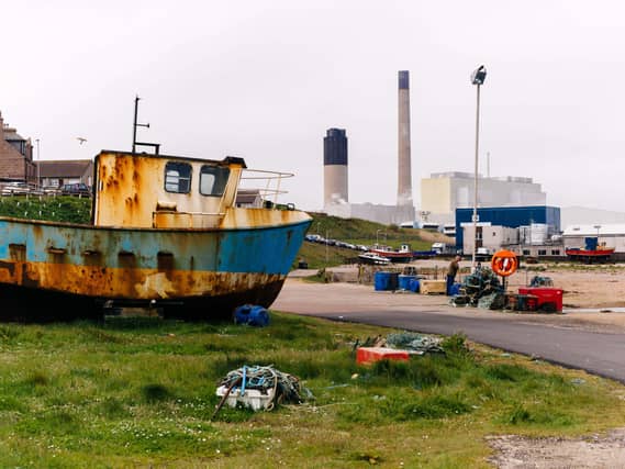 A photo of Peterhead with a rusty fishing boat in the foreground