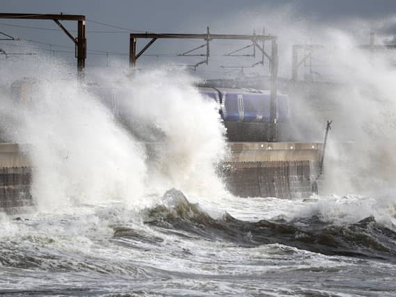 Waves crashing over a train