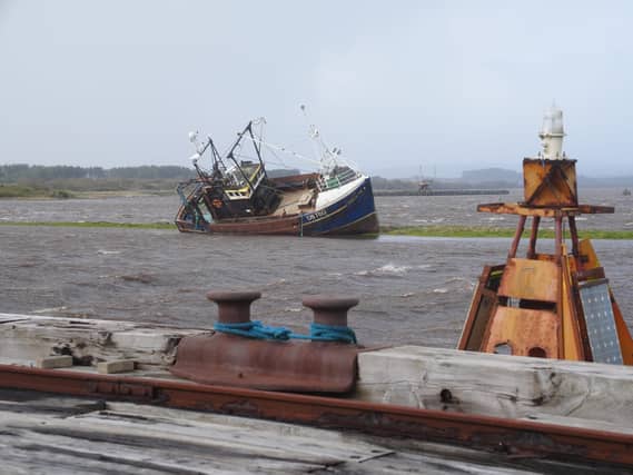 A fishing boat stranded in Irvine Harbour