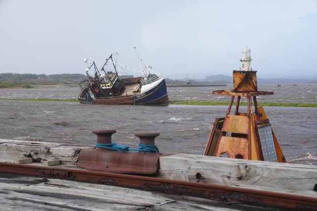 A boat which came loose from its moorings at Irvine harbour during Storm Boelo (Jane Barlow/PA)