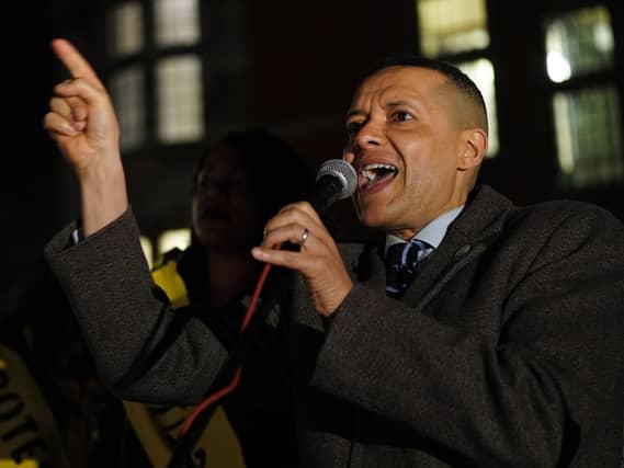 Clive Lewis speaking into a microphone and pointing