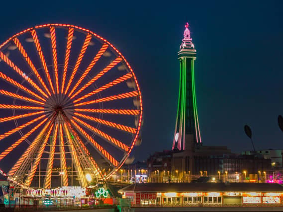 Blackpool Tower and a Ferris wheel lit up at night