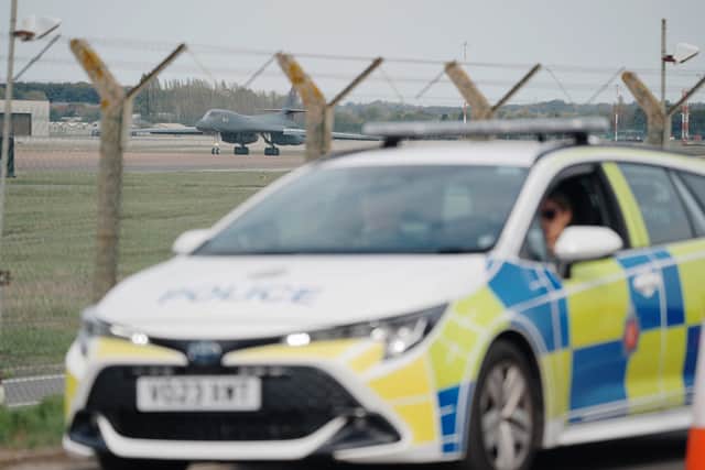 Police patrolling the perimeter at RAF Fairford in September (PA)