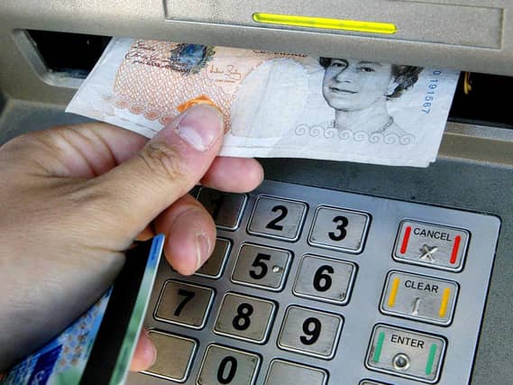 Cash being withdrawn