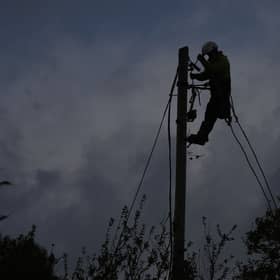 A network technician on a power pole