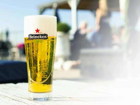 A pint of lager in a Heineken glass