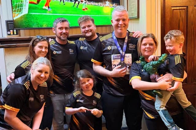 Jamie, family and friends all wearing Miles for Mum and Donegal Hospice jerseys