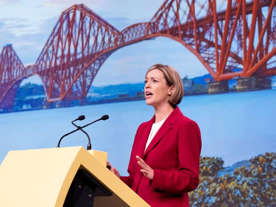 Jenny Gilruth speaking on stage in front of a picture of the Forth Bridge
