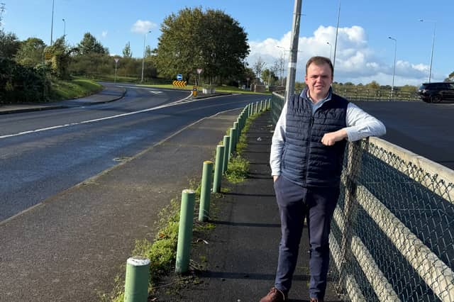 Cllr Dan McSweeney stands on the site of the proposed bus shelter in Clarina