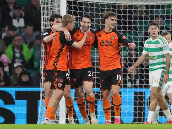 Neil Farrugia (centre) celebrates with team-mates after scoring