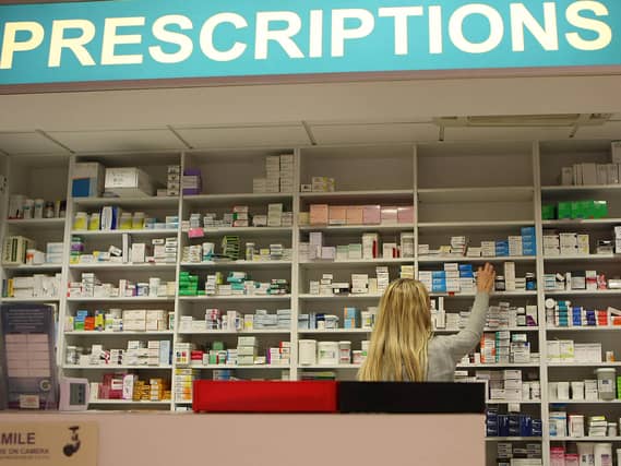 A pharmacist stocks shelves at a chemist