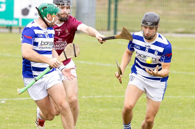 Naas midfielder Mac Dara Moore goes clear from the challenge of Leixlip wing-back James Canning with Liam Walshe in support in IHC action