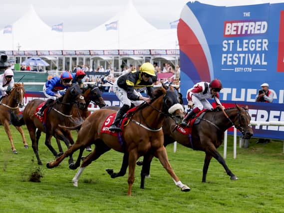 Air Force One ridden by Clifford Lee (5) on their way to winning for Bond Thoroughbreds at Doncaster