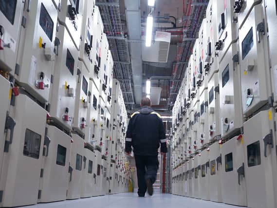 A man walking through a large data centre