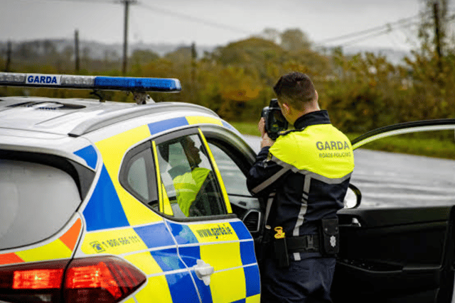 Garda with speed camera stock image