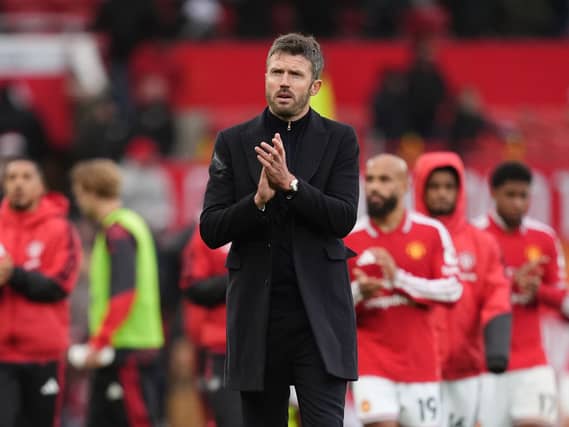 Manchester United manager Michael Carrick applauds the fans